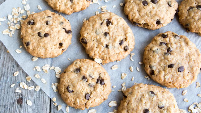Cowboy cookies and oats on parchment paper