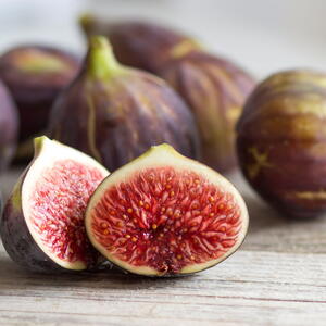fig fruit on a table, one cut open