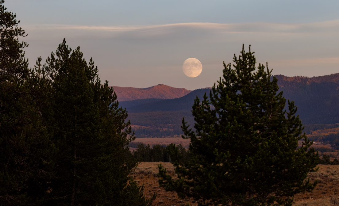A full Harvest Moon above the mountains of Jackson Hole, Wyoming.